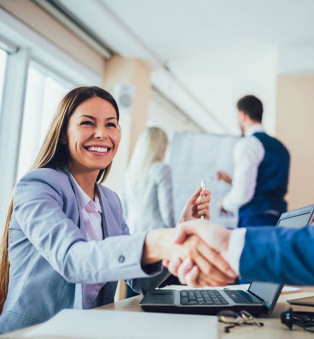 Woman in suit shaking hands with someone