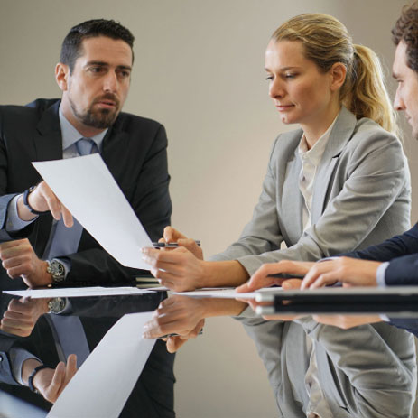 Three people looking at a sheet of paper