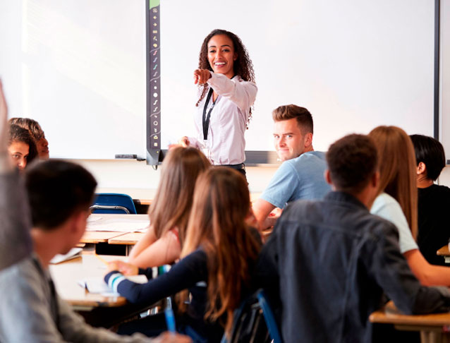 Woman pointing to students sitting down.